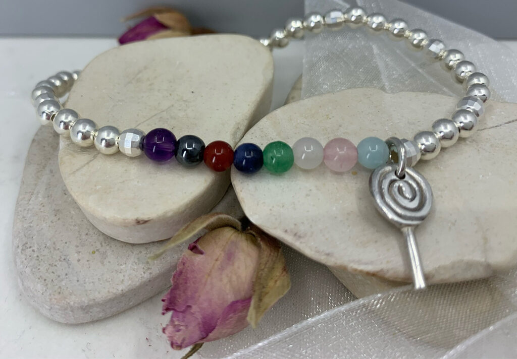 Handmade silver and semi precious bead stretch bracelet with lollypop charm.