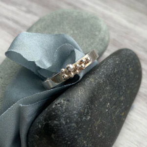 silver ring, recycled pebbles, scattered on the top