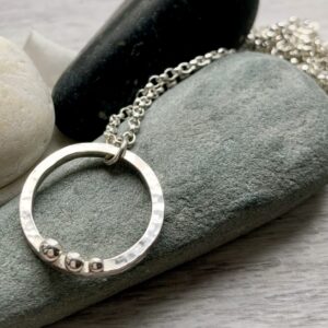 recycled sterling silver circle pendant hammered texture three pebbles