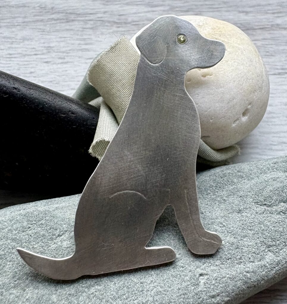 Handmade recycled silver dog brooch, peridot eye, birthstone August, personalised jewellery gift.
