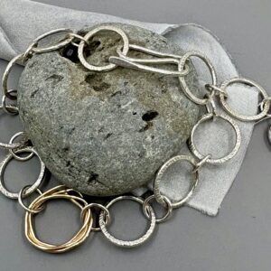handmade silver and 9ct gold link bracelet with recycled pebble detail